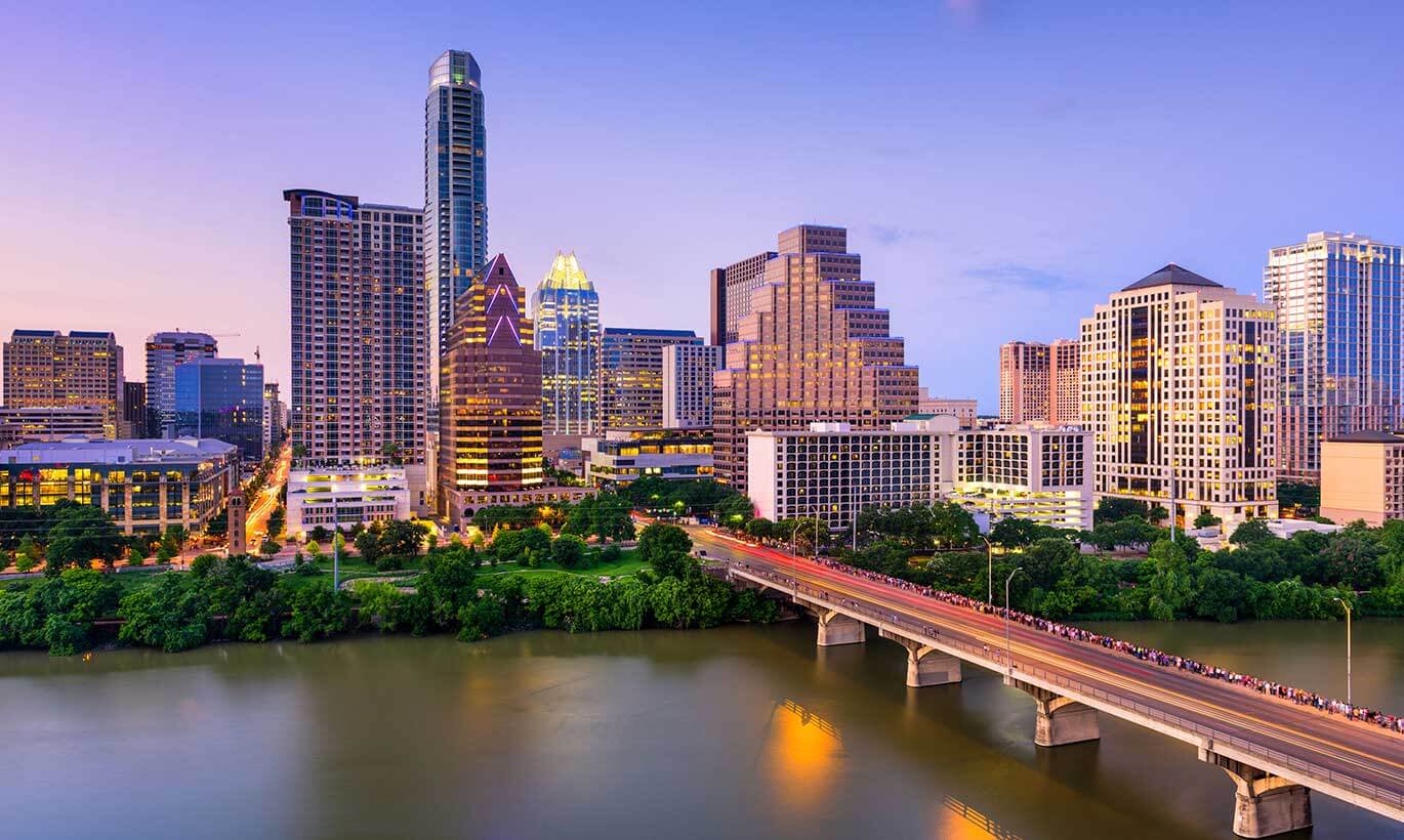 The Austin, Texas skyline lit up during sunset.