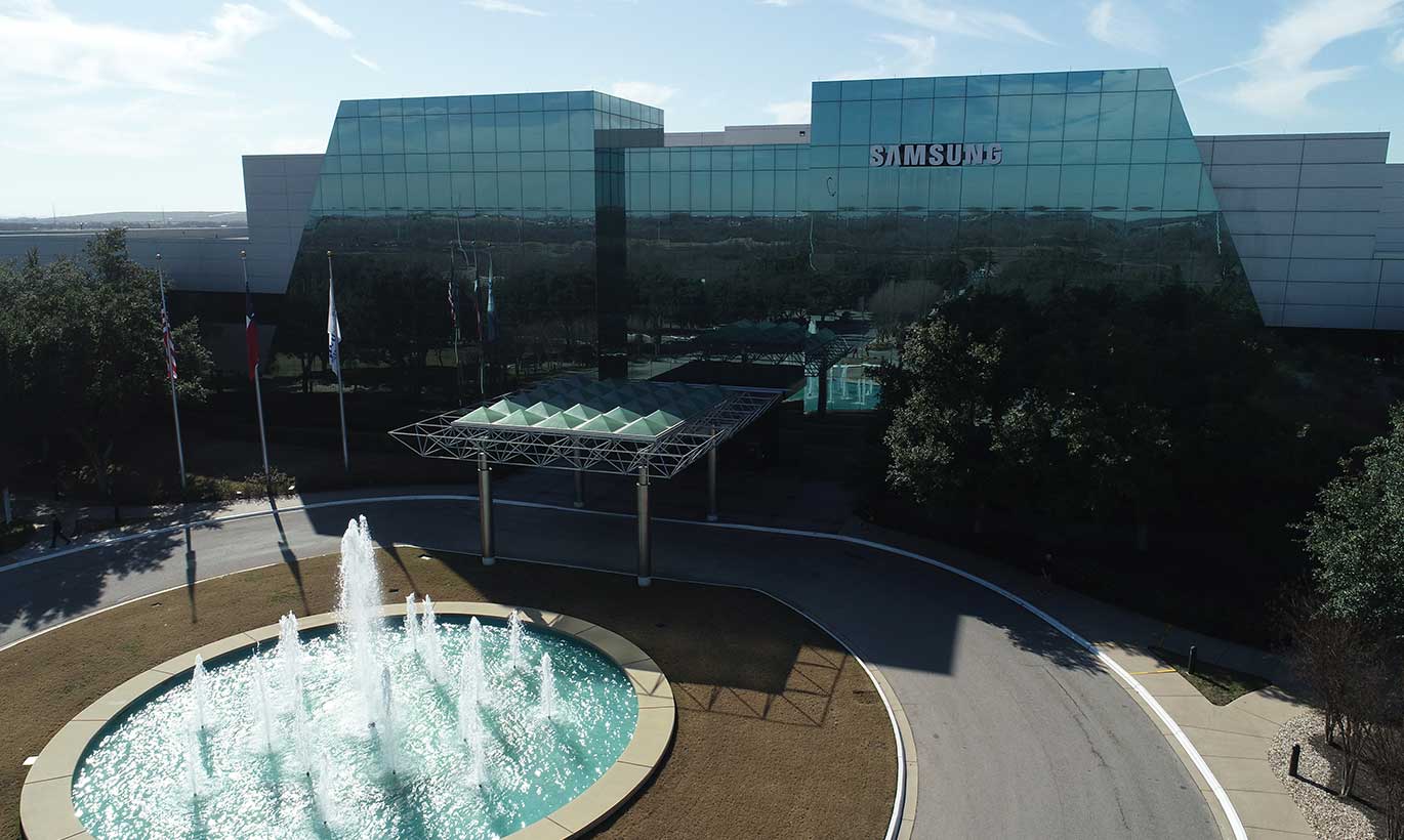 A large fountain outside the mirrored Samsung building