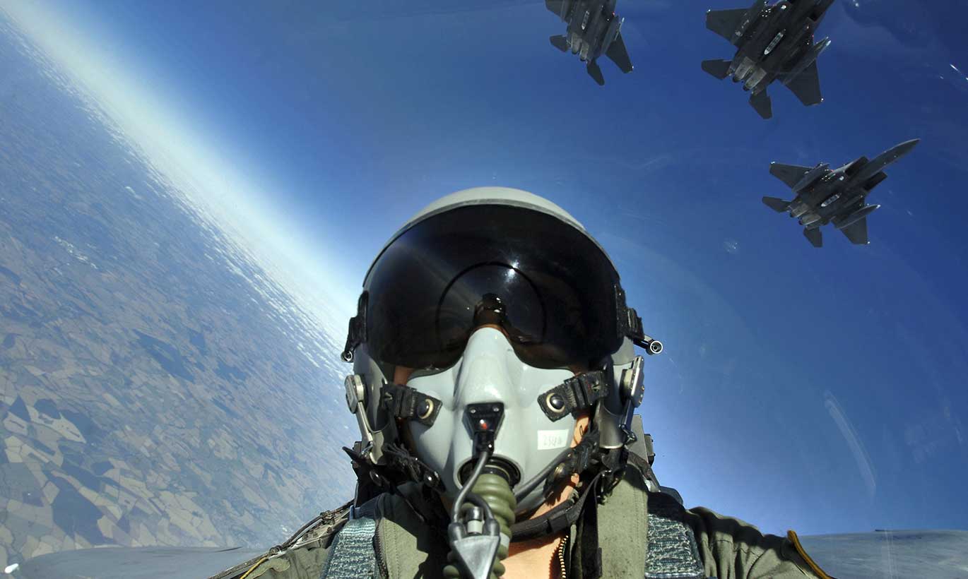 A pilot in the military taking a selfie in his plane