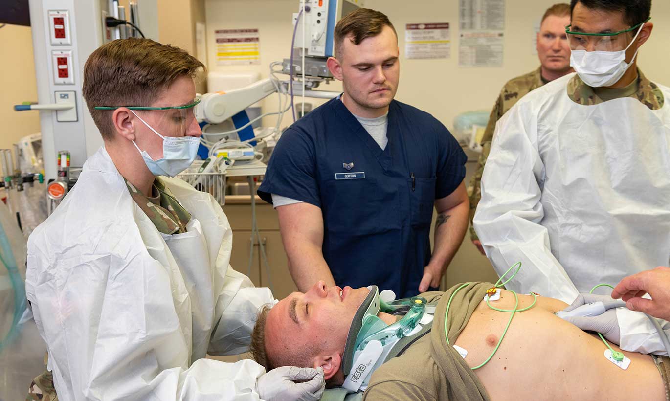 Nurses and technicians the San Antonio Military Medical Center run tests on a patient