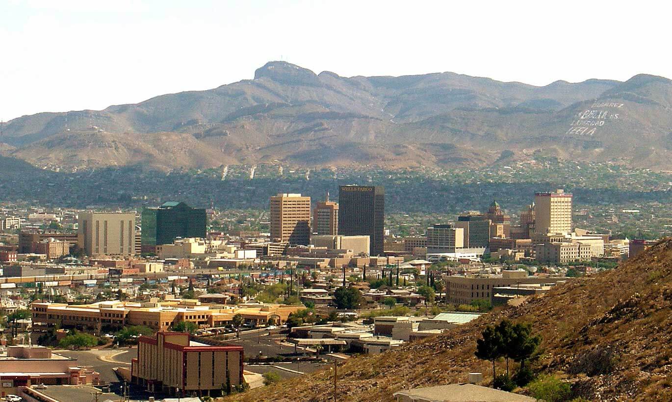 The West El Paso skyline features tall office buildings and large mountains in the background.