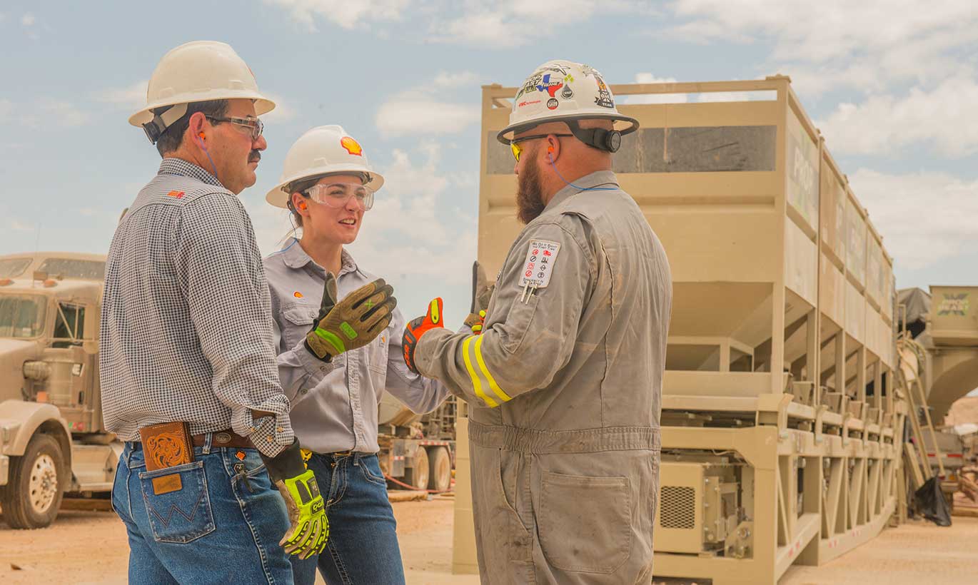 Two men and a woman working at Shell in Texas.