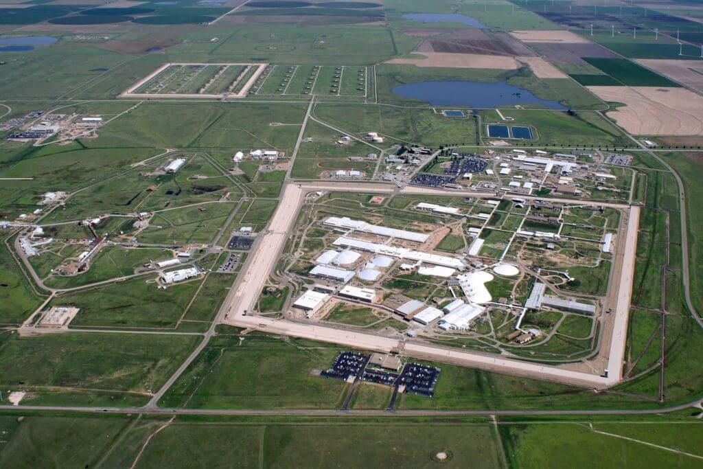 Aerial view of manufacturing facilities in Amarillo, Texas, surrounded by green grassy areas.