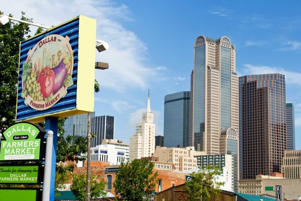 The Dallas Farmers Market sits against a background of the Dallas skyline in Texas.
