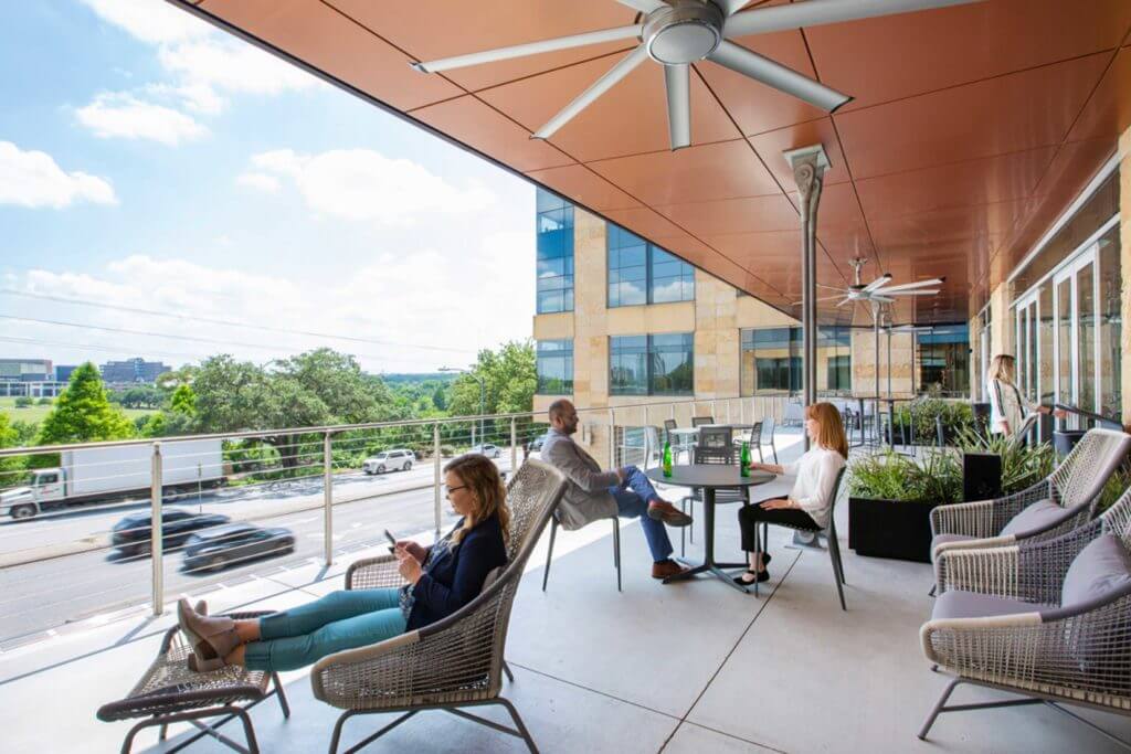 The outdoor patio space of the Silicon Labs office building filled with workers in Austin, Texas