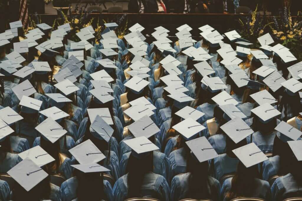 A view looking down at college graduates in their caps and gowns.