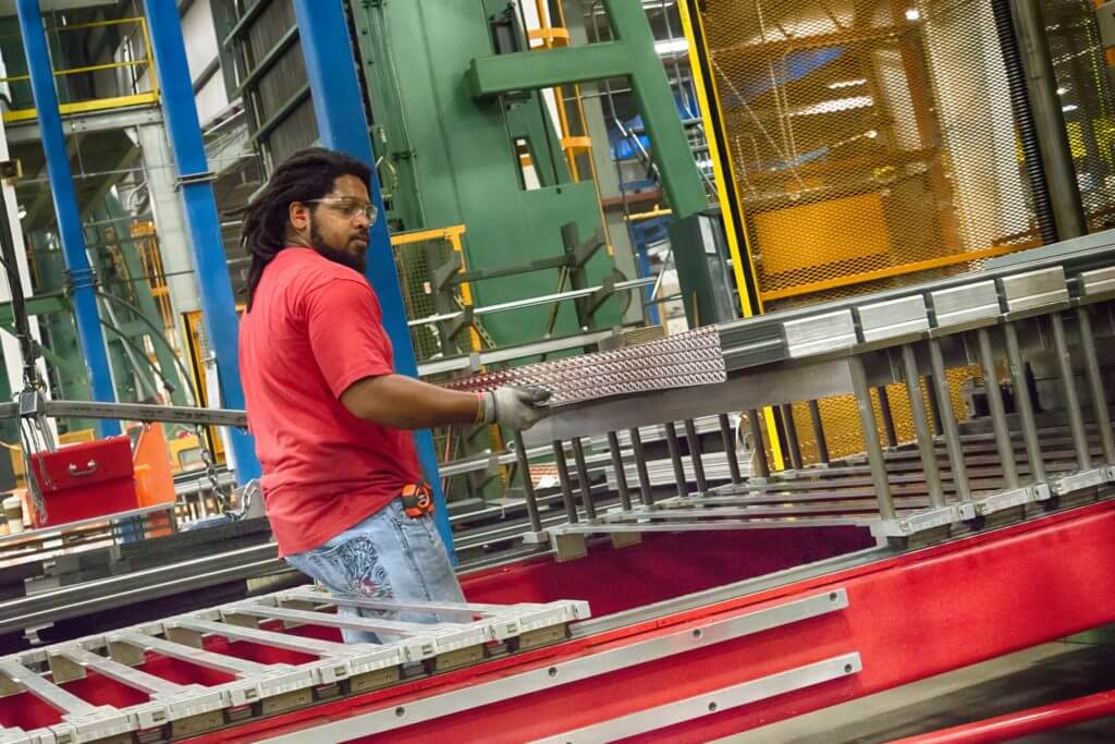 A man works with equipment at AAON, a first-class HVAC manufacturing company in Longview, Texas