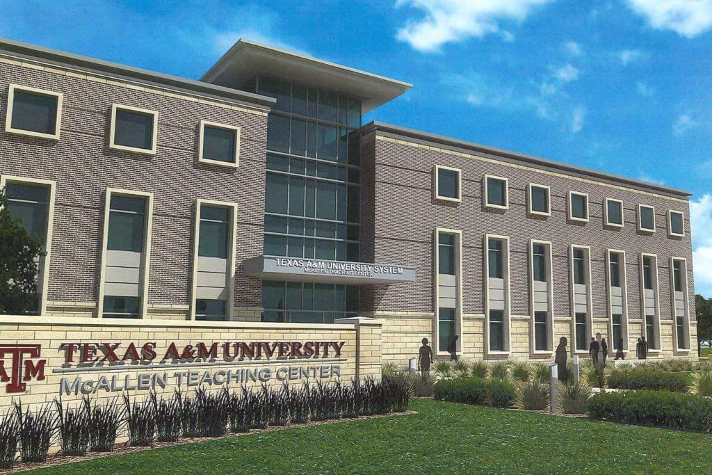 A white brick sign outside a college building reads "Texas A&M University McAllen Teaching Center"