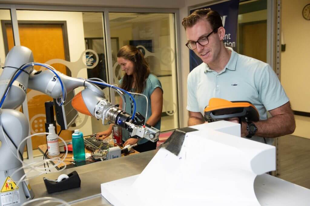 Man and woman work with robotics equipment at the Southwest Research Institute in San Antonio, Texas