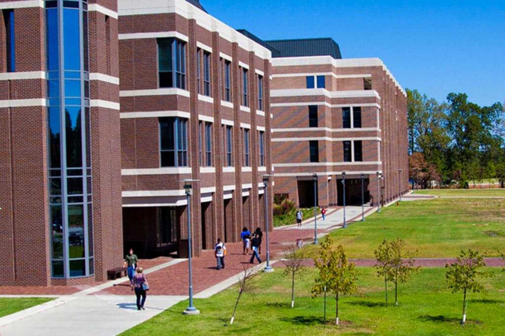 Students walk around outside a university building in Texarkana, Texas.