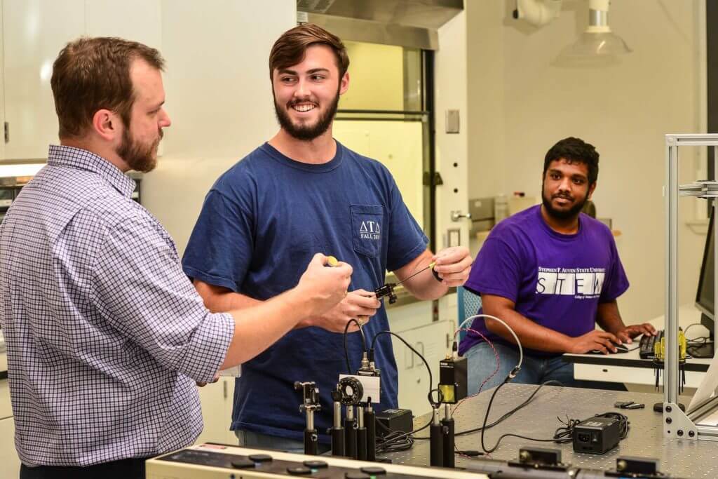 Two STEM students working with equipment at Stephen F. Austin State University in Nacogdoches, Texas