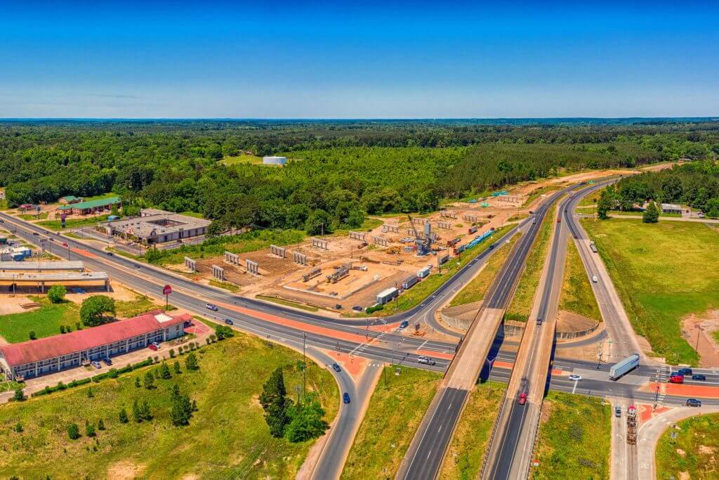 Aerial view of cars driving on a major interstate in Texas Forest Country