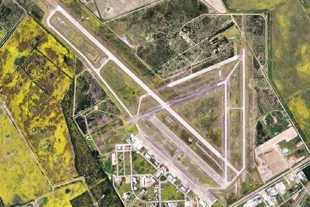 Aerial view of Victoria Regional Airport, including the long runways and airplanes.