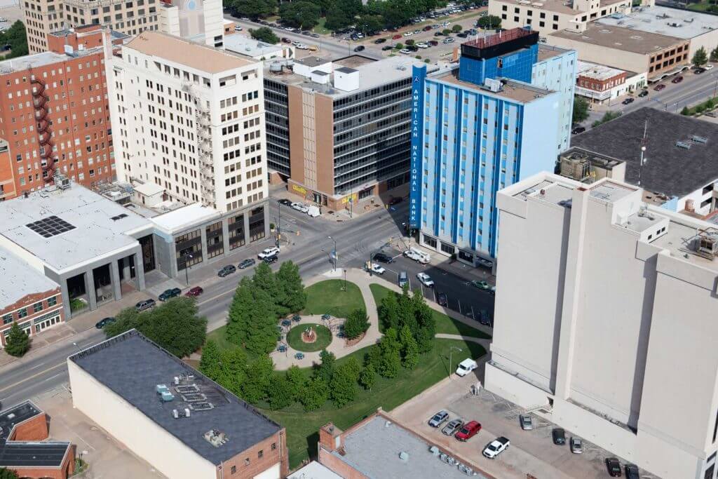 A view of downtown Wichita Falls, Texas with local businesses surrounding a small park