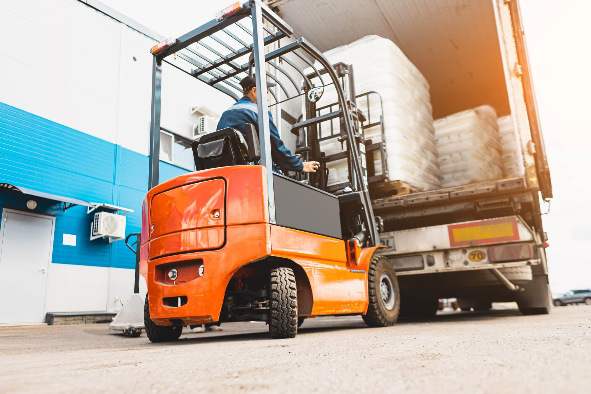 Man using a forklift to move pallets for transportation