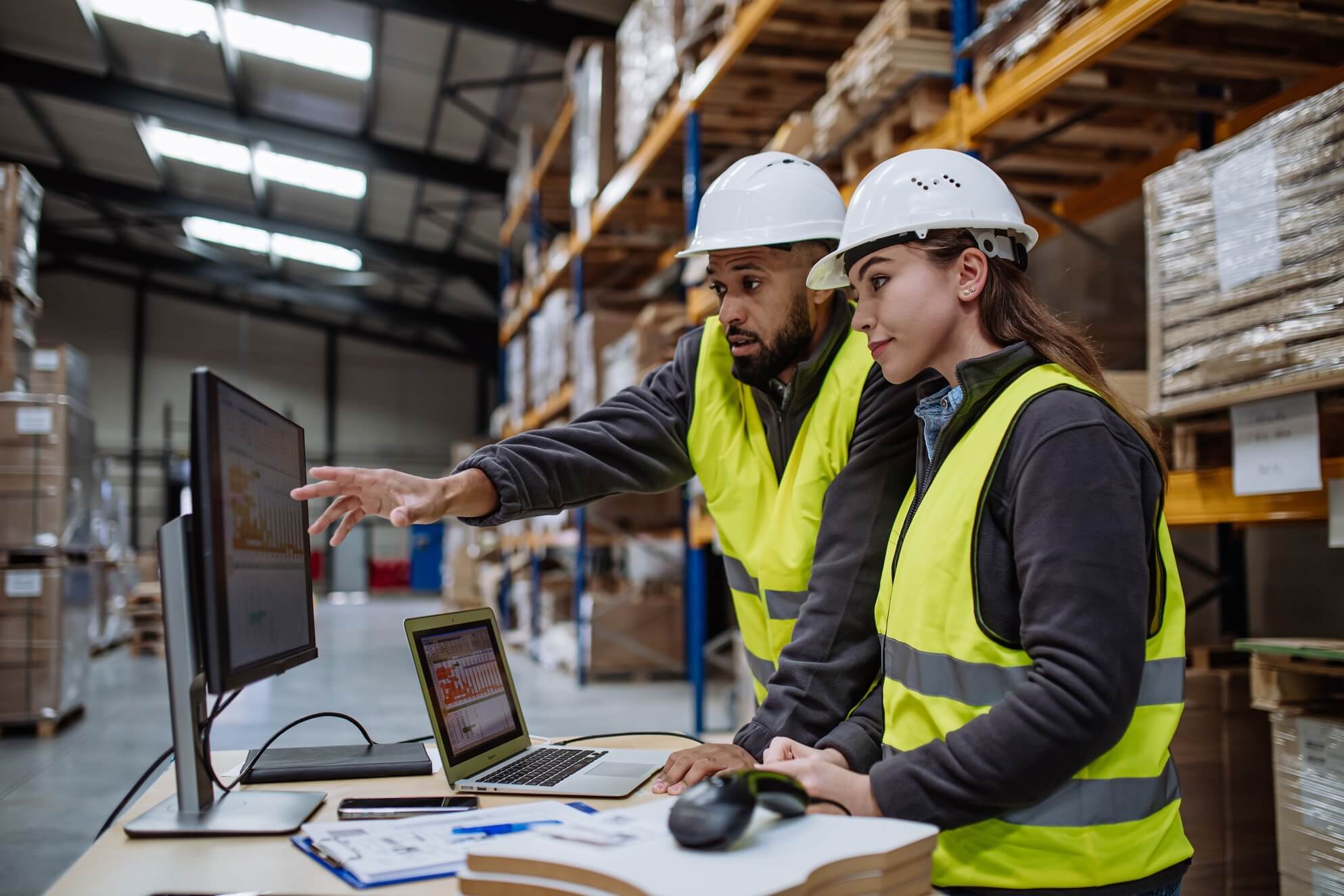 Two warehouse employees working on logistics for shipments