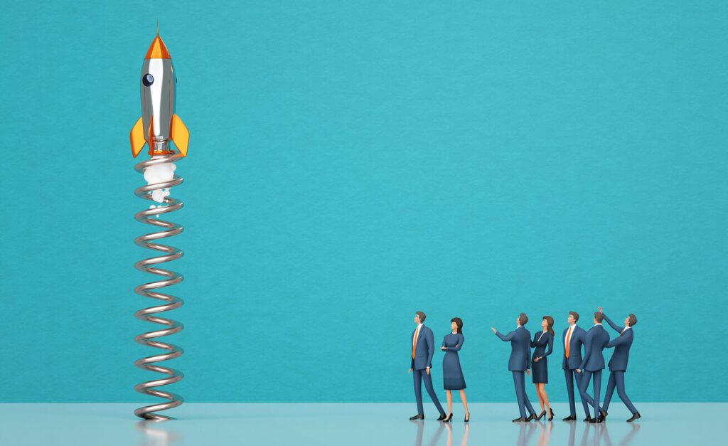 Business people watching rocket start up symbolizing new business, start ups, and taking a risk by investing in new industries in Texas