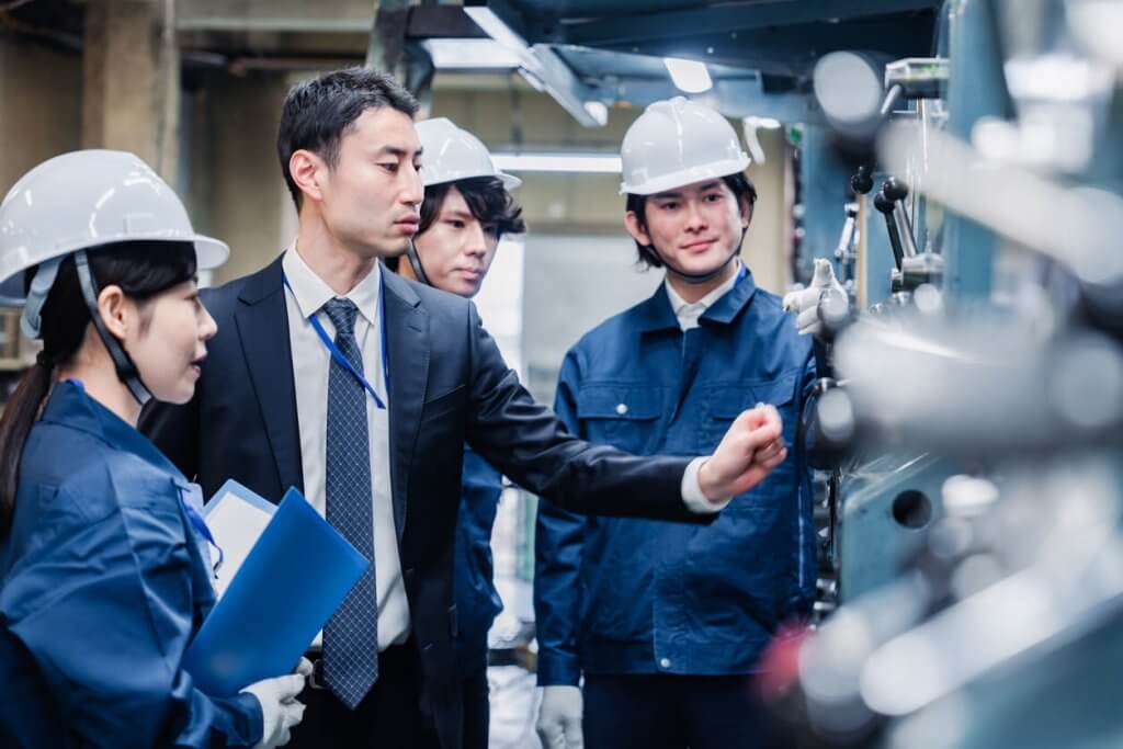 Management directing manufacturing factory workers in Texas