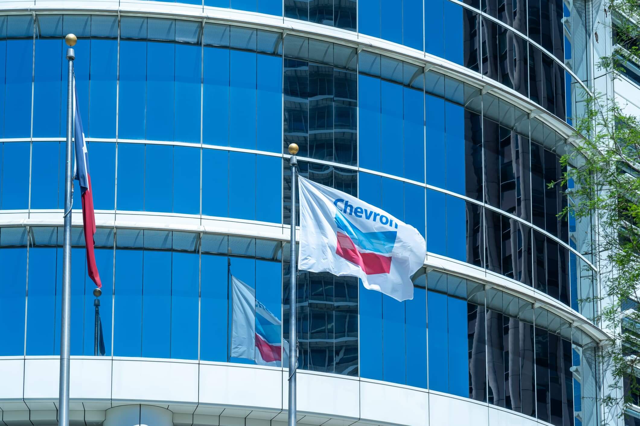 The flags at Chevron Corporation office building in Houston, Texas, USA. Chevron Corporation is an American multinational energy corporation