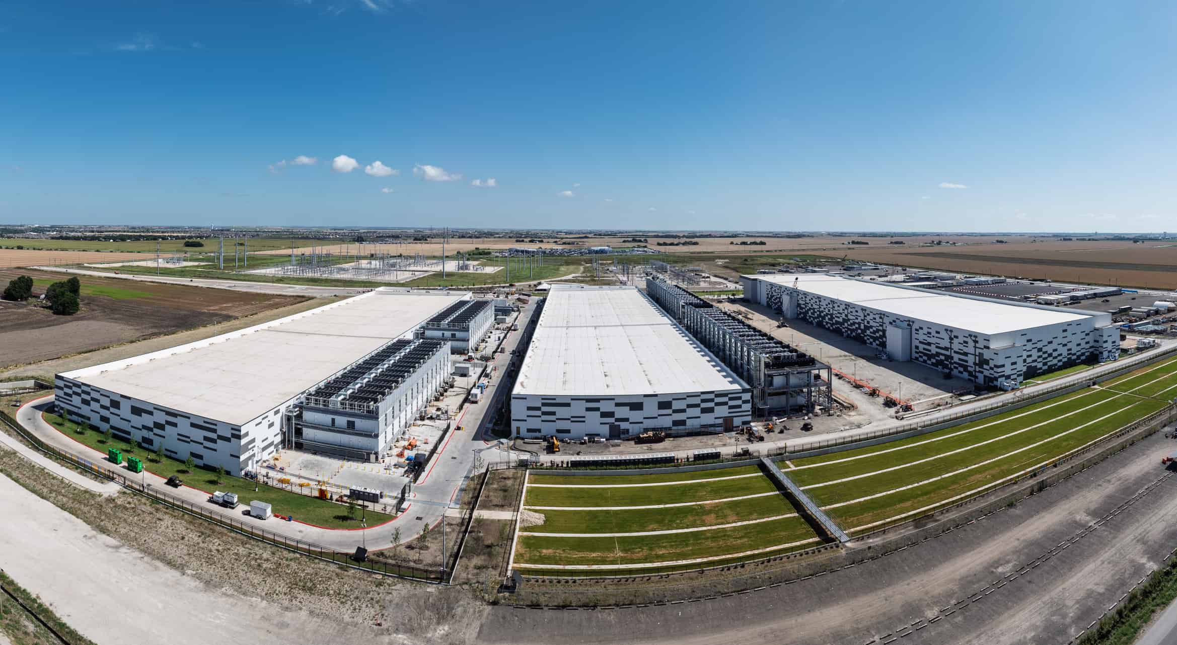 Aerial view of a large data center campus in Hutto, Texas, with three massive buildings with 400M square feet of space and 600MW power capacity